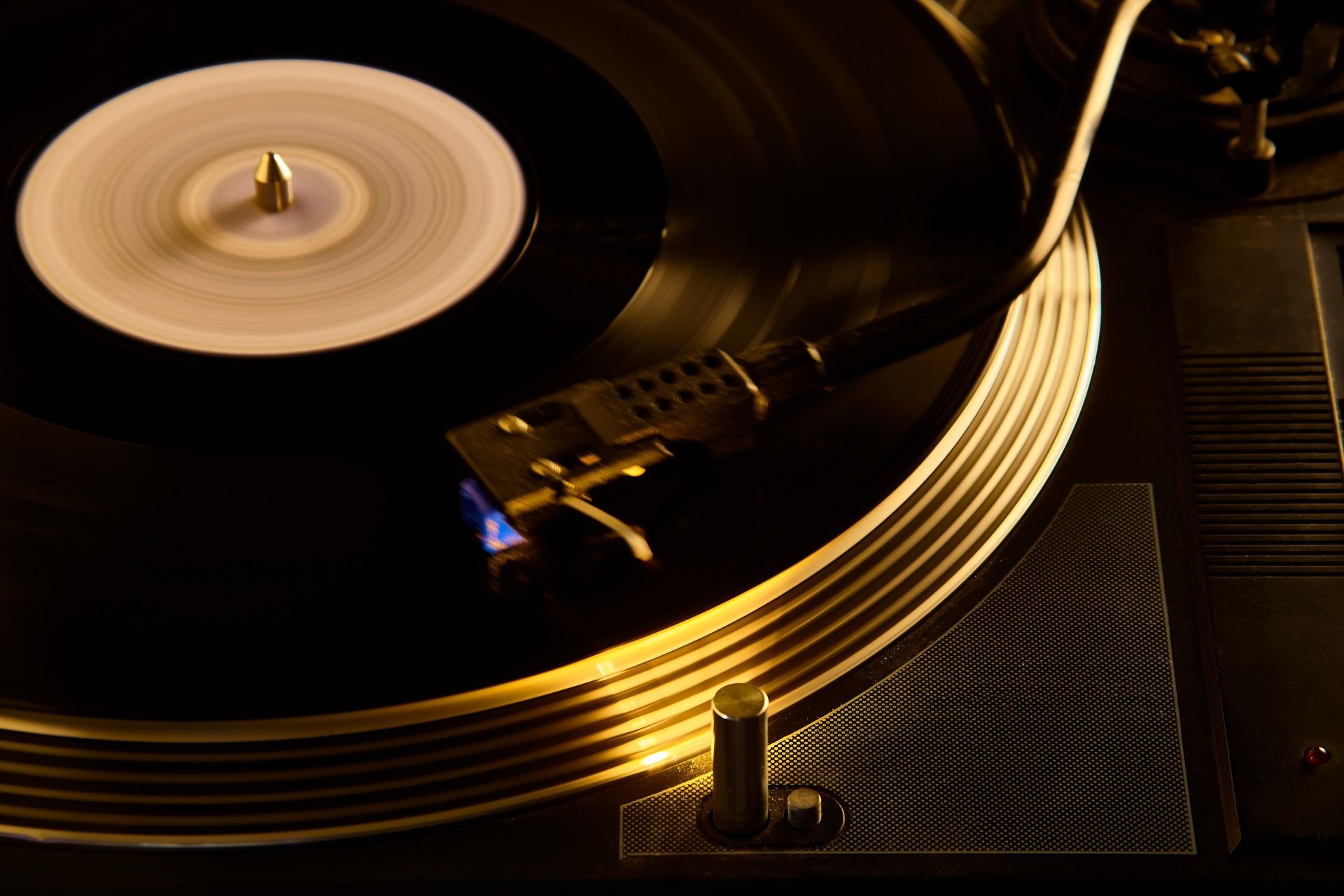 Vintage turntable with movement effect on the vinyl record while playing inside a disco.